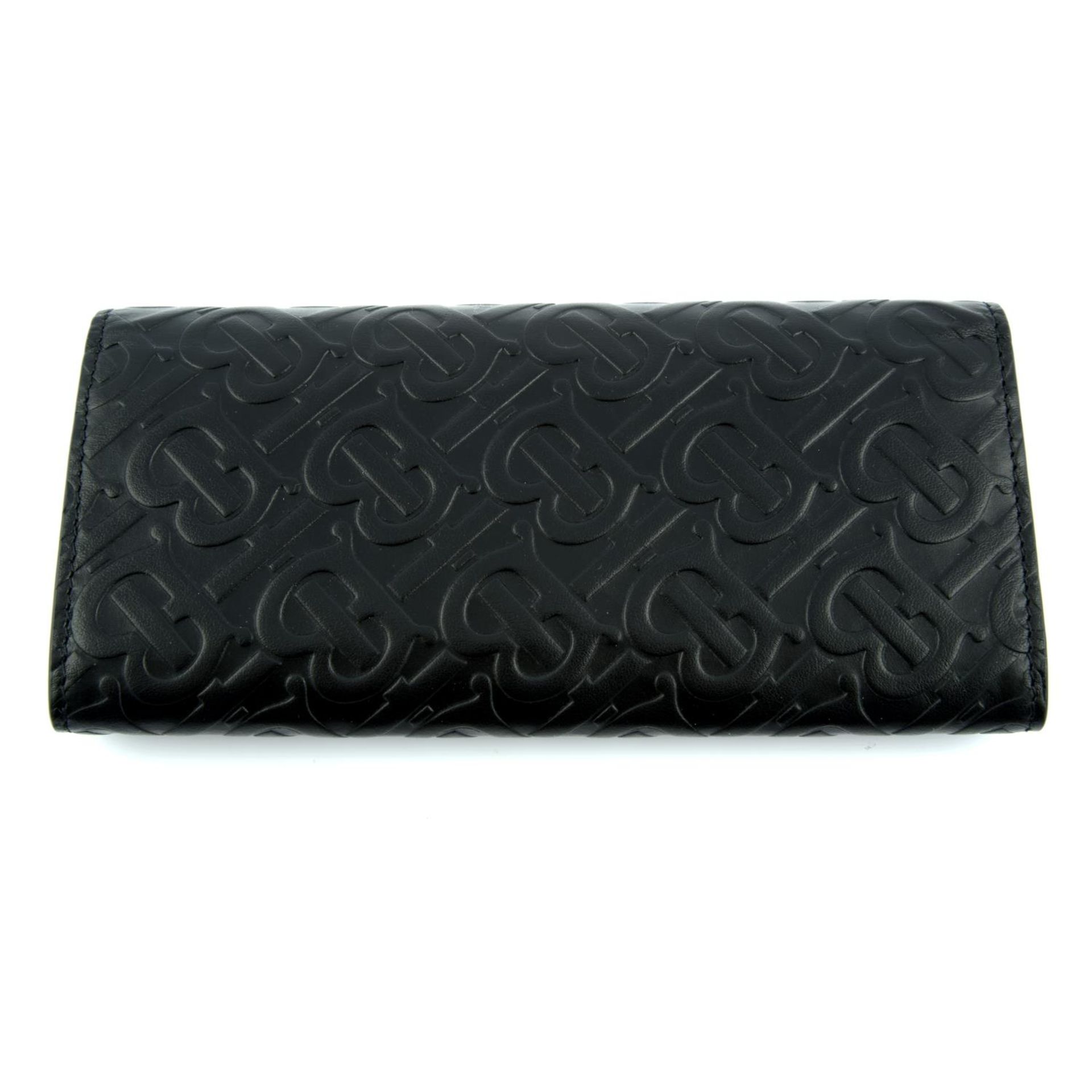 BURBERRY - a black leather monogram continental wallet. - Image 2 of 4