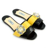 PRADA - a pair of patent leather embellished slip on sandals.