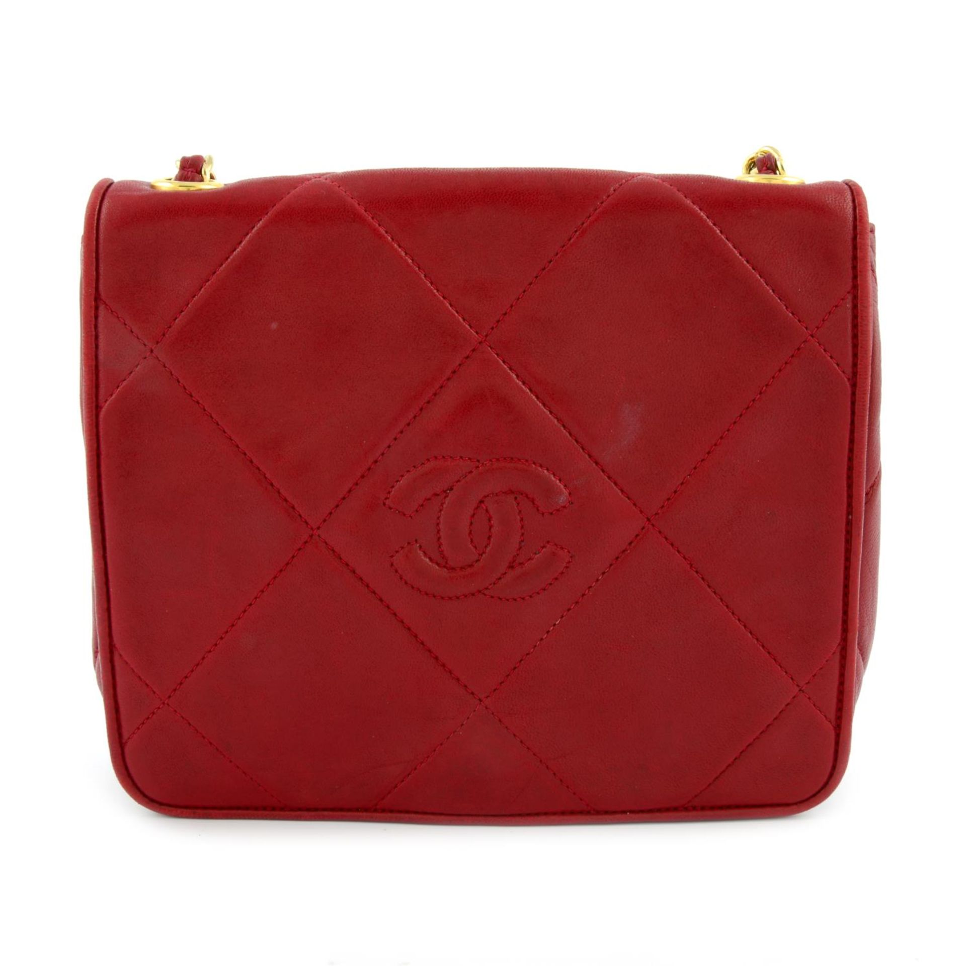 CHANEL - a red leather flap crossbody handbag.