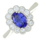 An 18ct gold tanzanite and diamond cluster ring.Estimated total diamond weight 0.35ct.