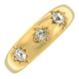 An 18ct gold old-cut diamond gypsy-set three stone ring.Estimated total diamond weight