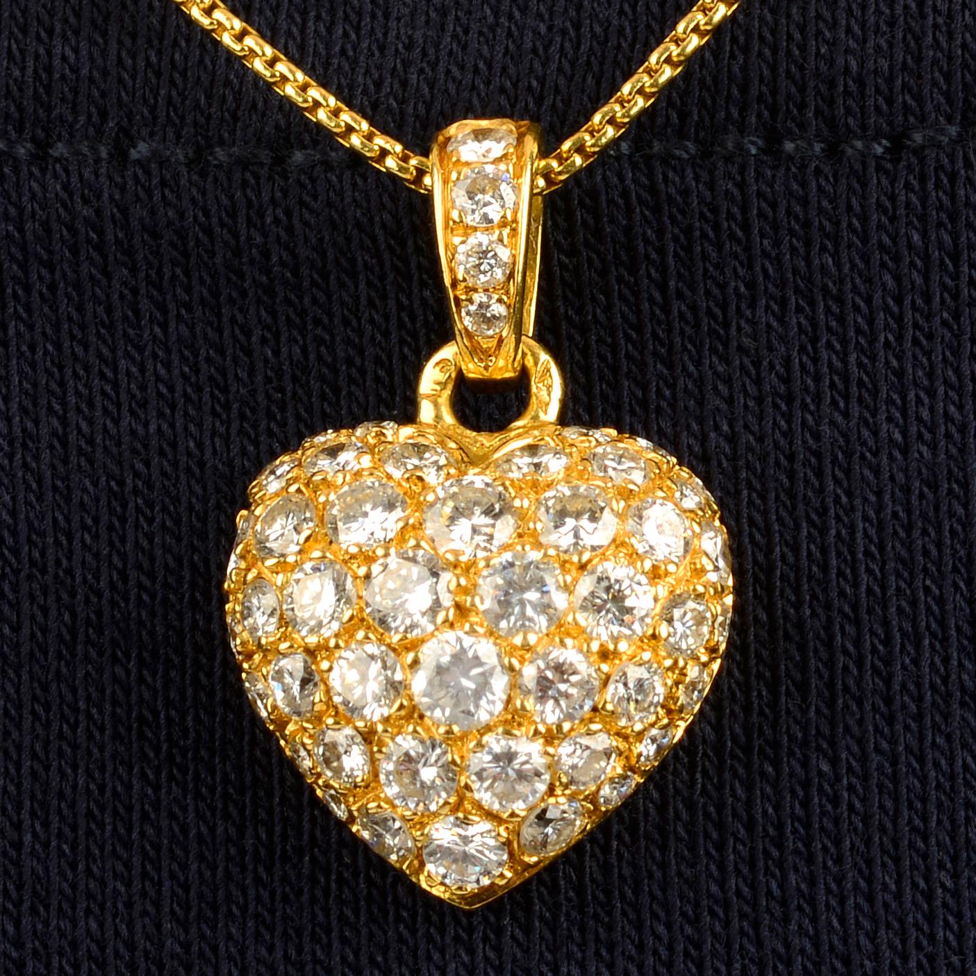 A pavé-set diamond heart pendant, by Cartier, with non-designer chain ...