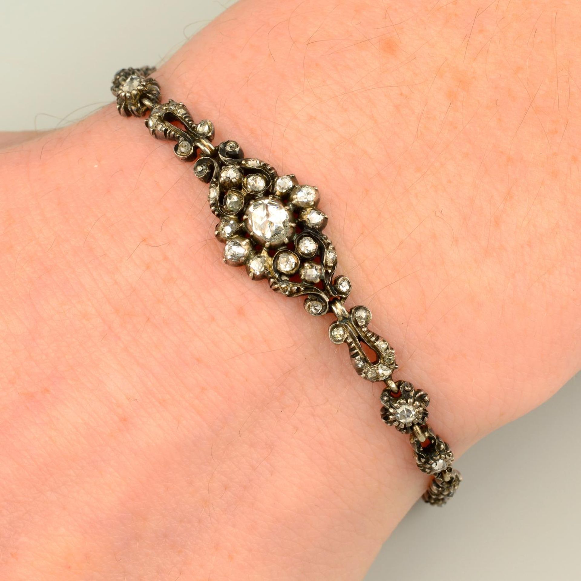 A rose-cut diamond floral bracelet.Length 18.4cms.