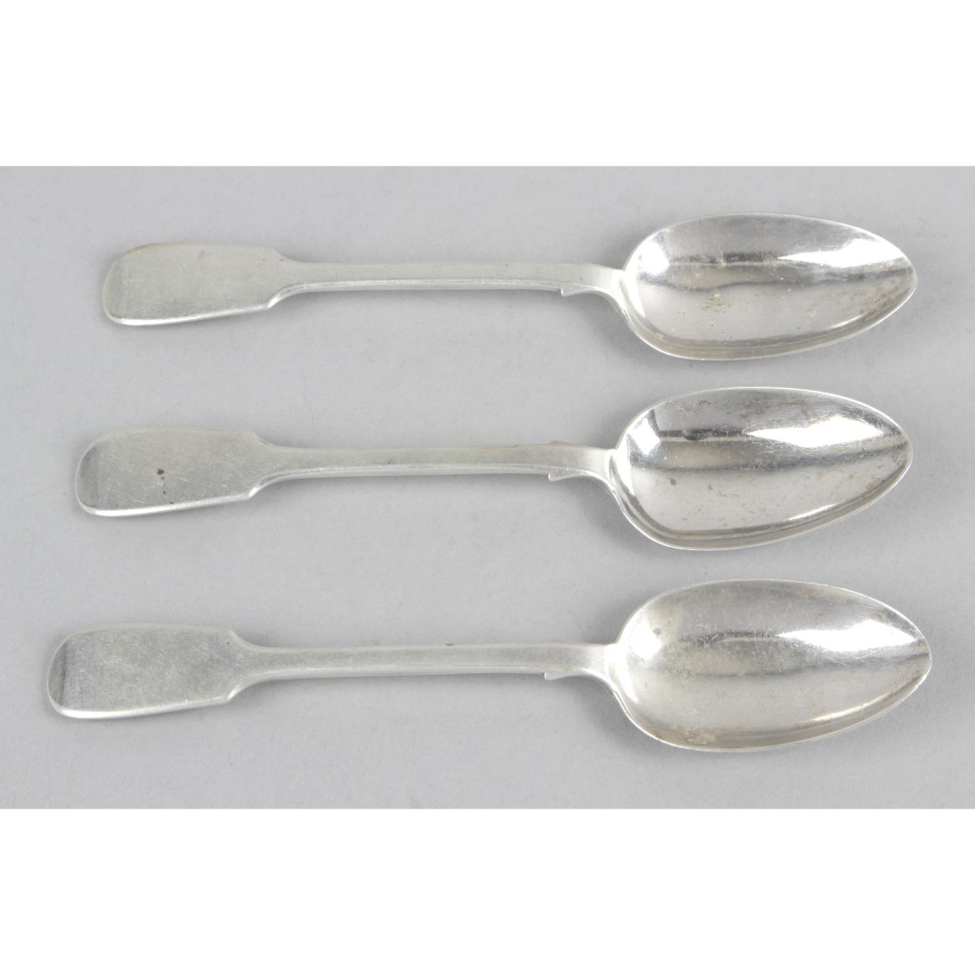 A set of three Newcastle silver dessert spoons,
