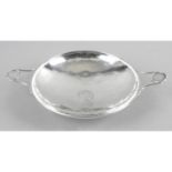 A silver twin-handled dish of circular form,