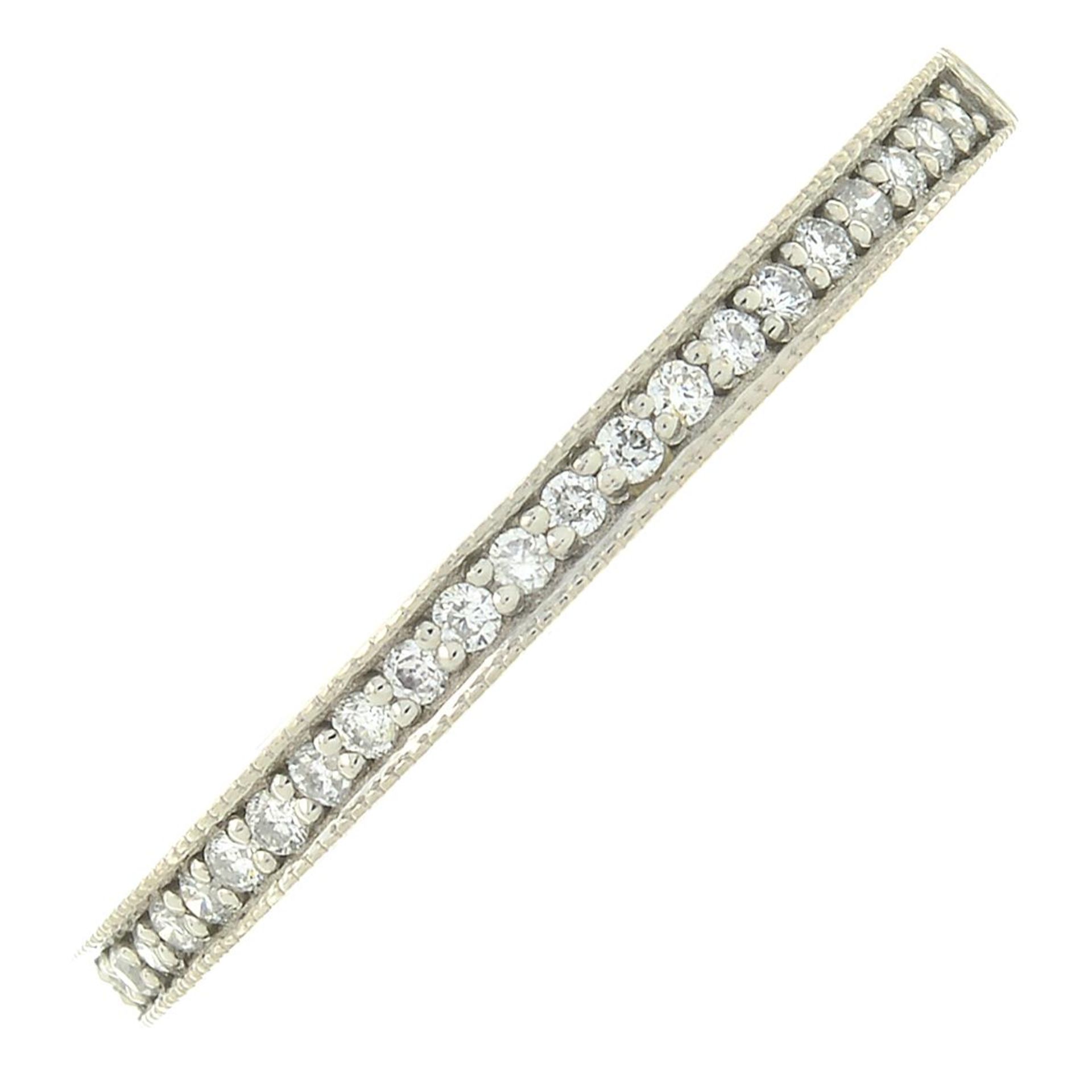 A palladium brilliant-cut diamond half eternity ring.Hallmarks for Birmingham.Ring size N.