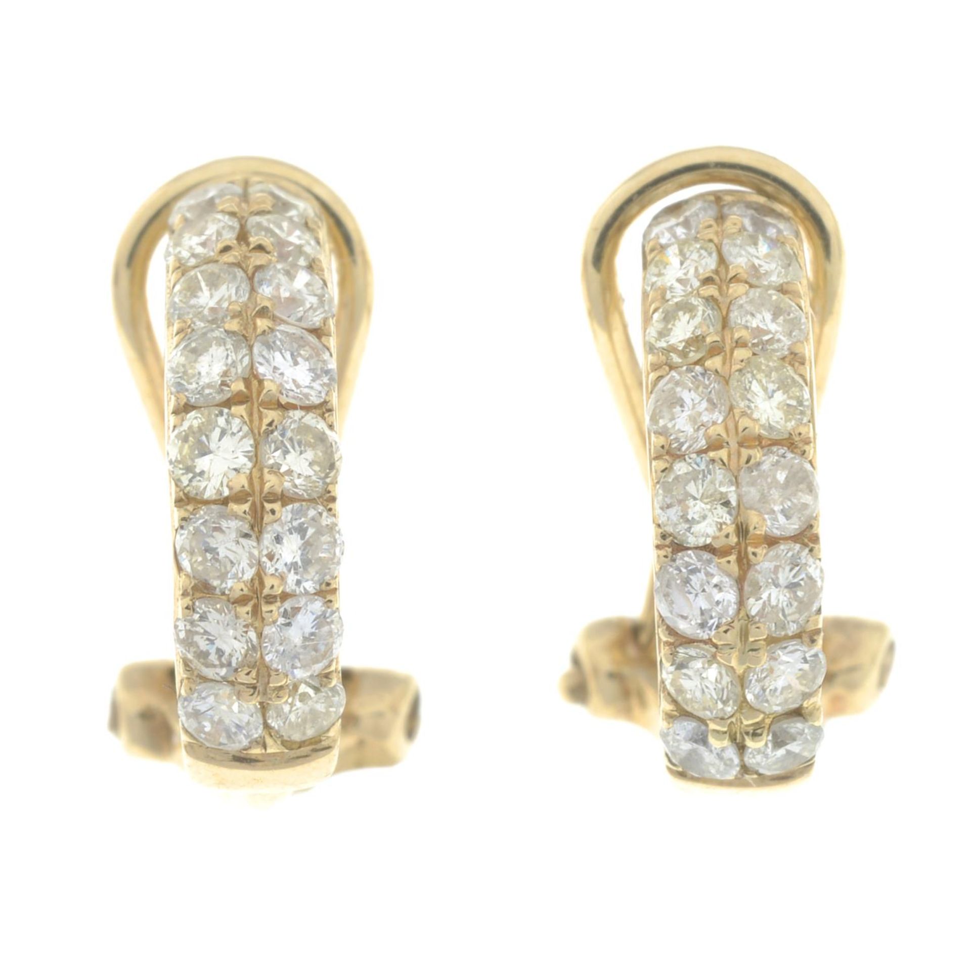 A pair of diamond earrings.Estimated total diamond weight 0.40ct.