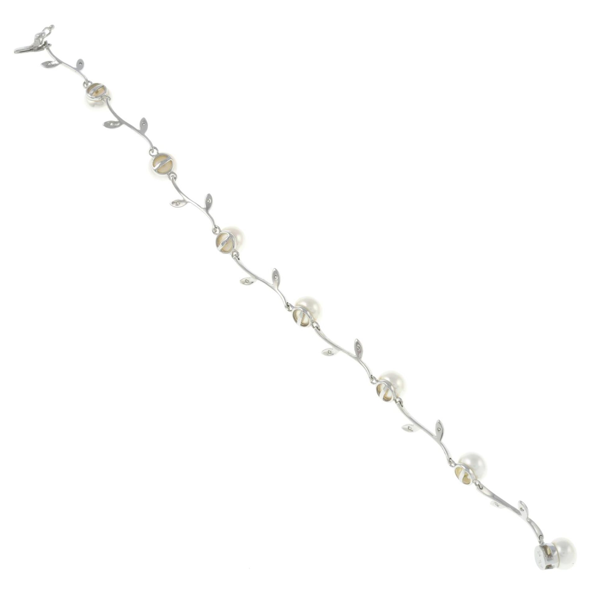 A 9ct gold cultured pearl and diamond floral bracelet.Hallmarks for 9ct gold.Length 17.3cms. - Image 2 of 2
