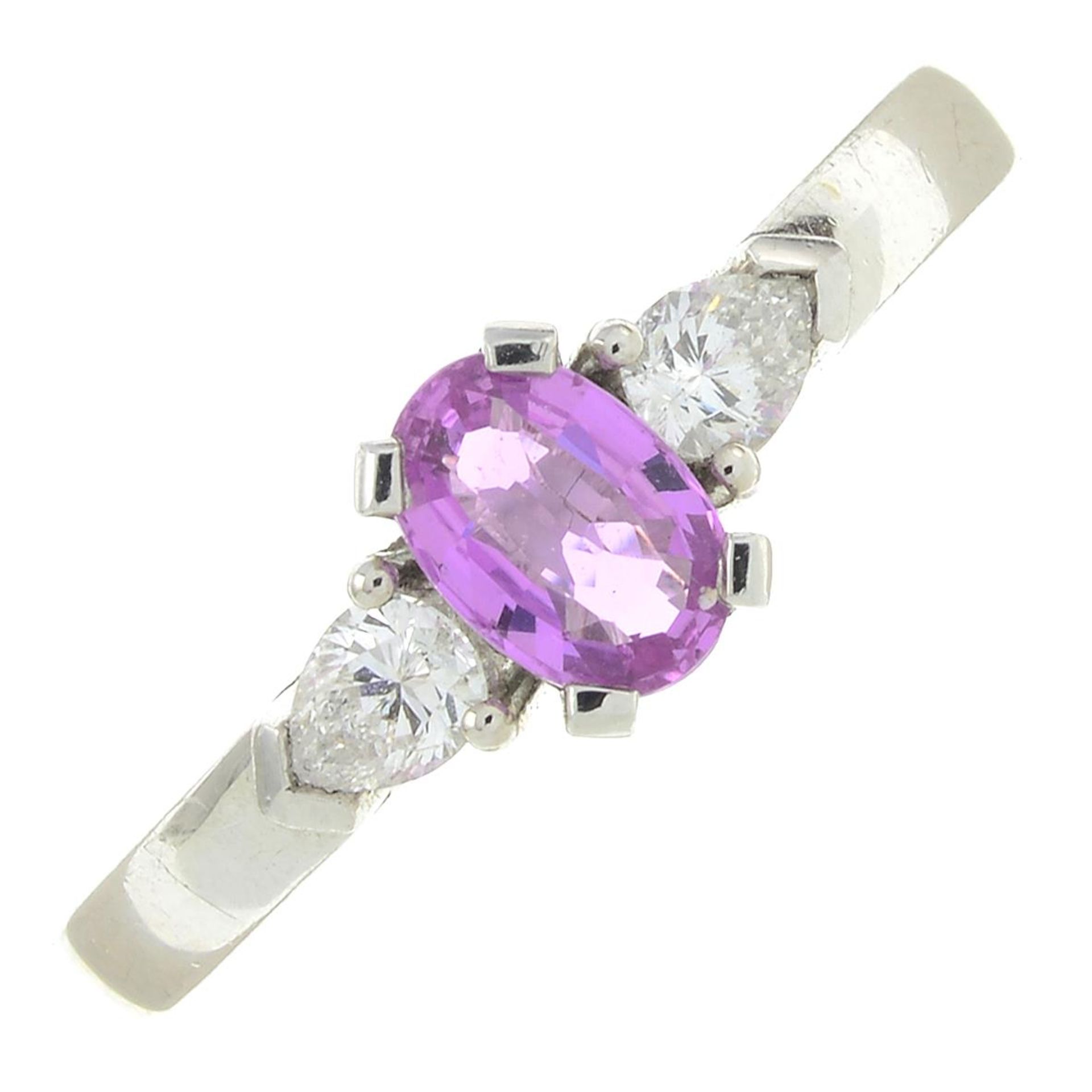 An 18ct gold pink sapphire and diamond three-stone ring.Estimated total diamond weight 0.25ct,