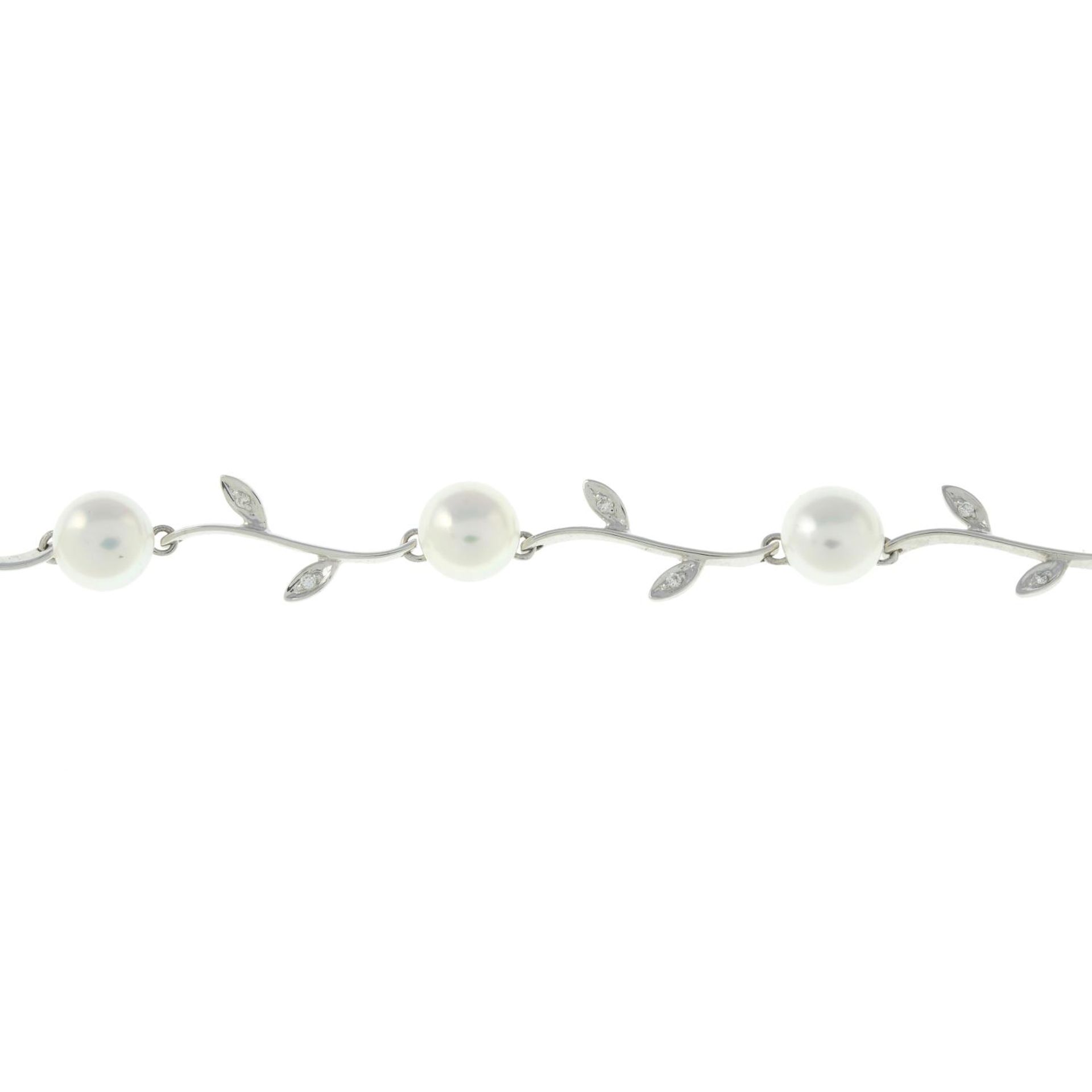 A 9ct gold cultured pearl and diamond floral bracelet.Hallmarks for 9ct gold.Length 17.3cms.