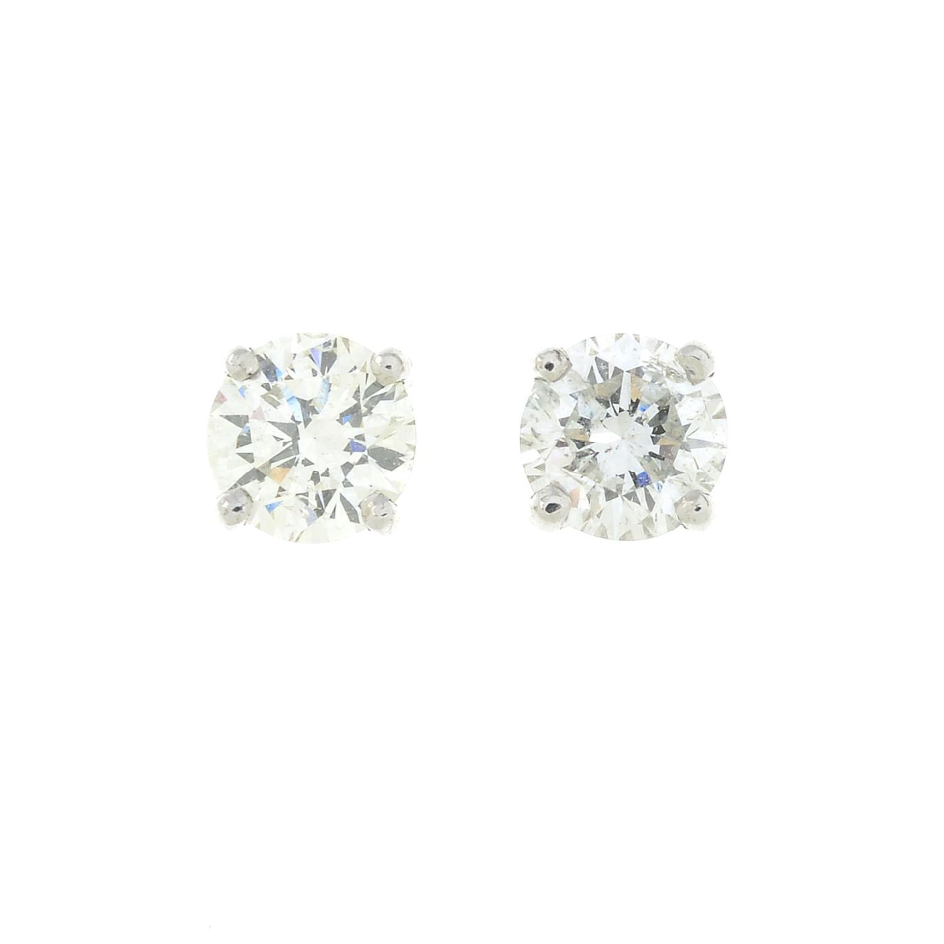 A pair of 18ct gold diamond stud earrings.Estimated total diamond weight 0.80ct,