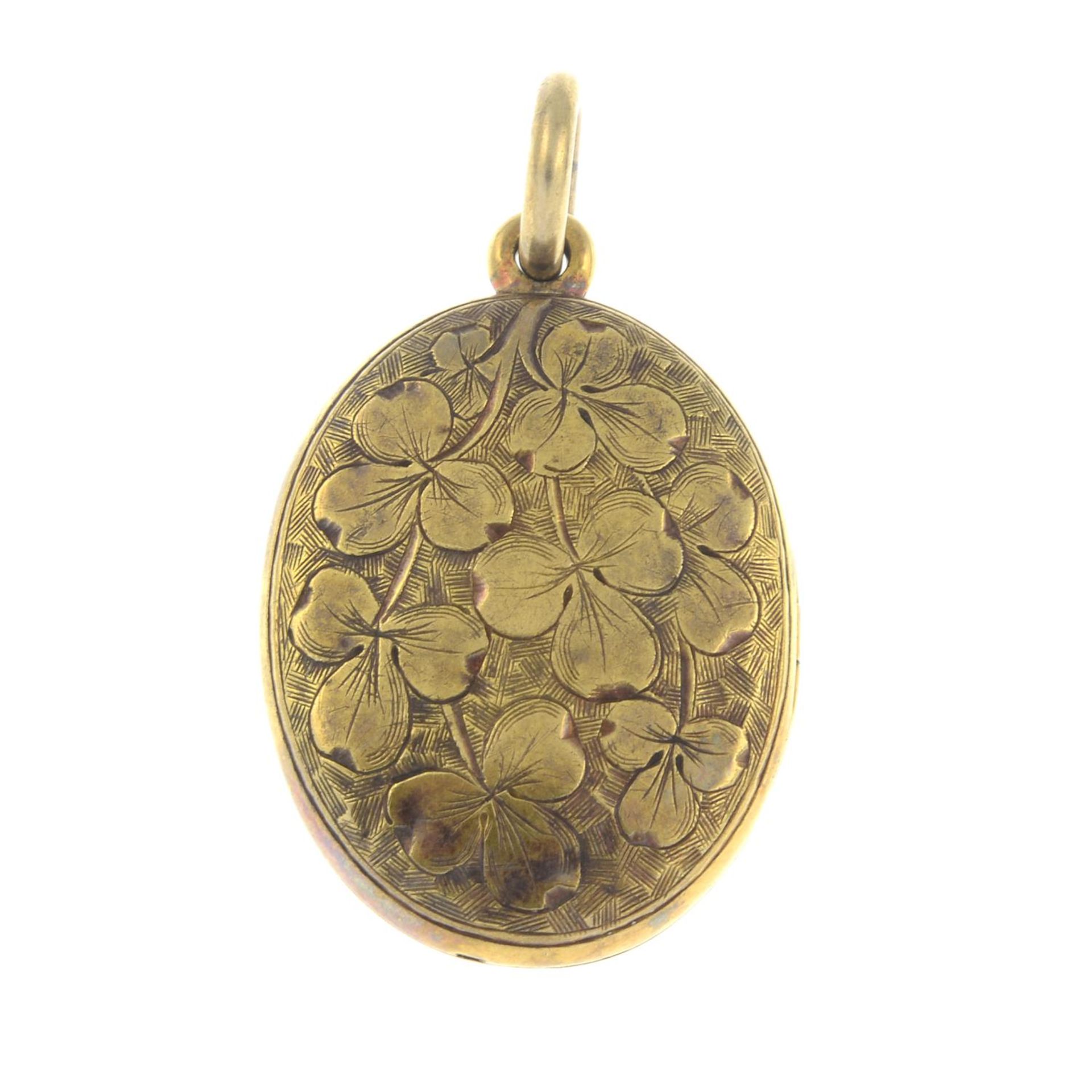 A late 19th century gold shamrock engraved locket pendant.Length 3.3cms.