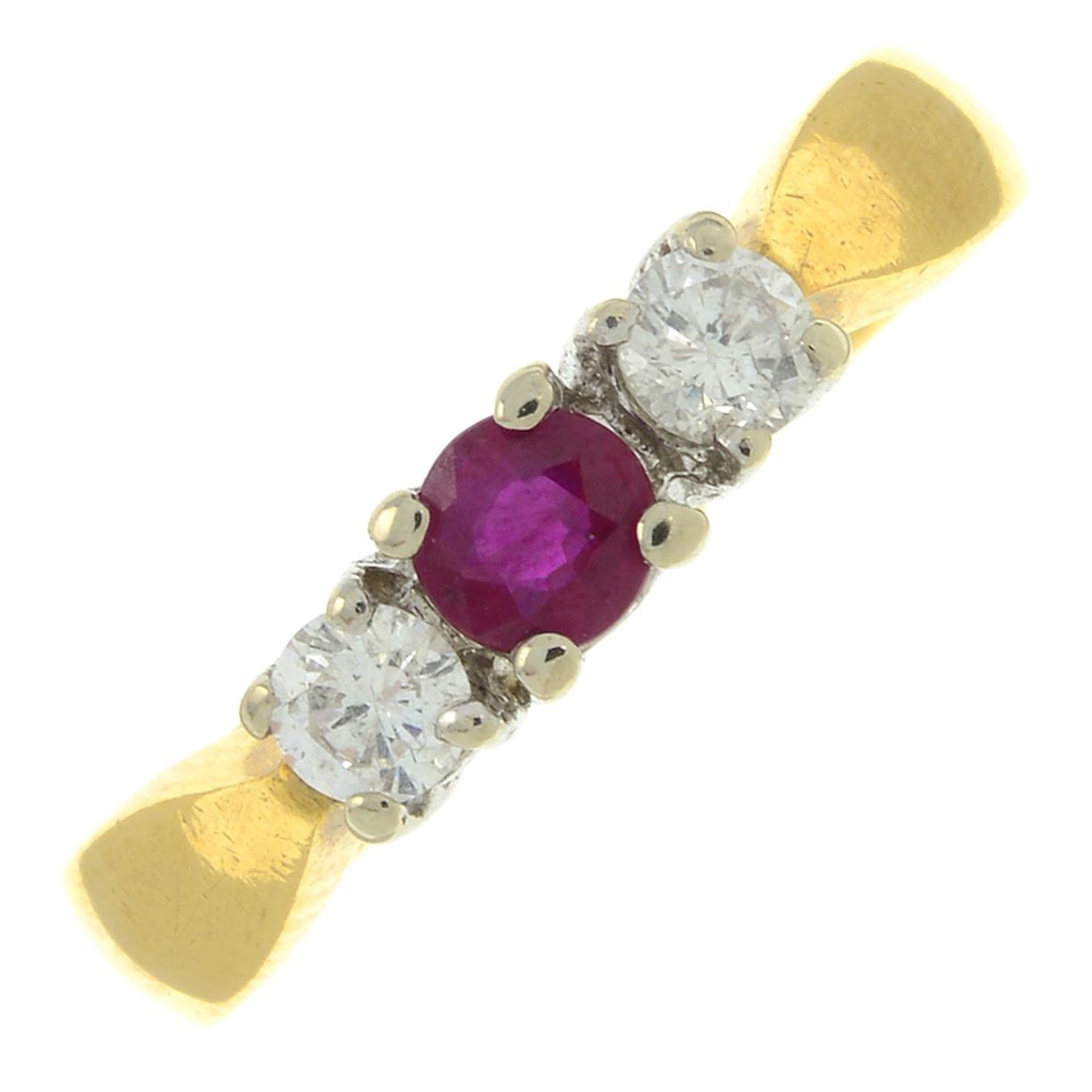 An 18ct gold ruby and diamond three-stone ring.Total diamond weight 0.25ct, stamped to band.