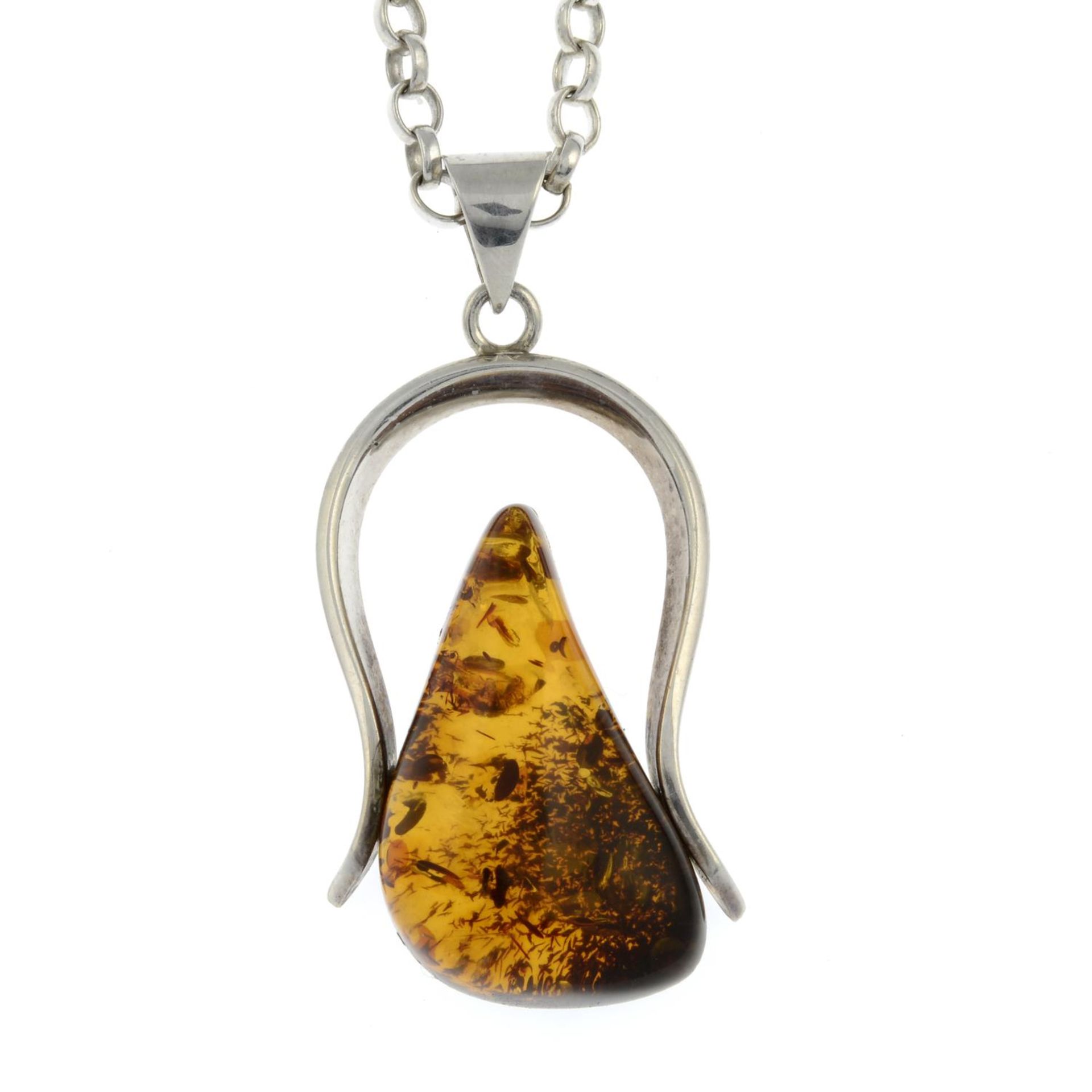 A silver modified amber pendant with chain,
