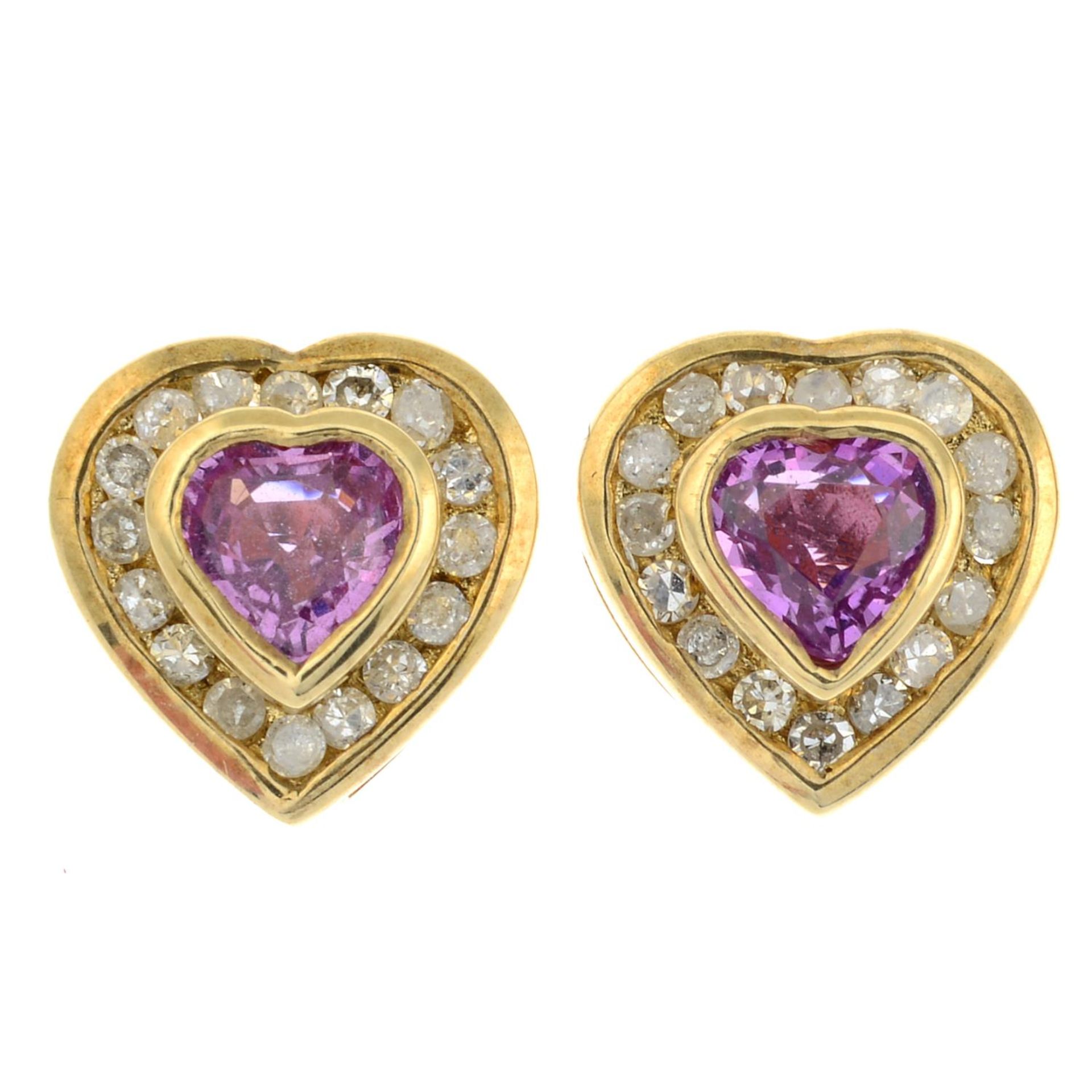 A pair of 9ct gold pink sapphire and diamond heart stud earrings.Estimated total diamond weight