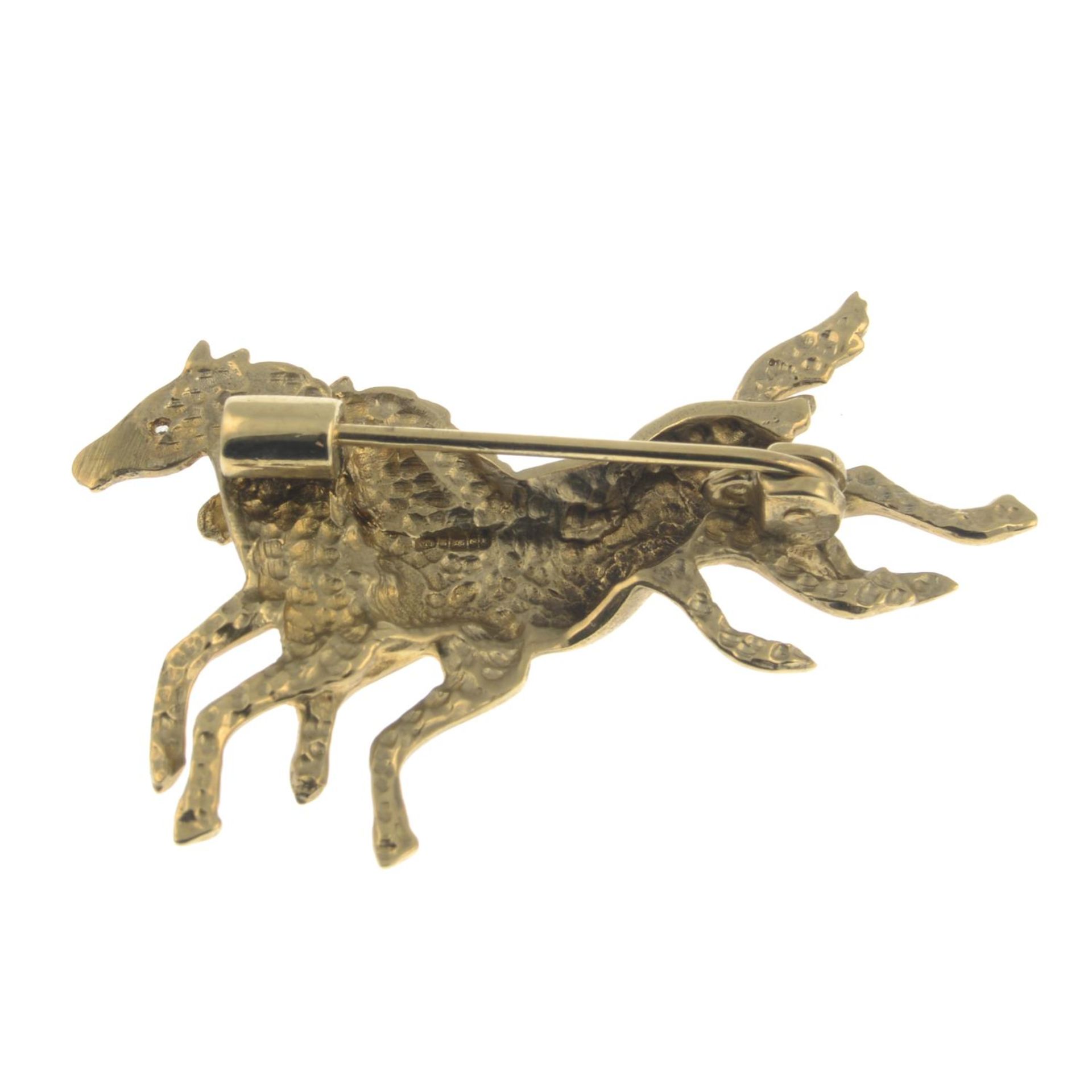 A 9ct gold brooch of galloping horses with diamond accents.Hallmarks for Birmingham.Length 4.8cms. - Image 2 of 2