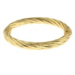 A 9ct gold hinge bangle of rope texture, by Uno-A-Erre.Hallmarks for Italy.Inner diameter 6cms.