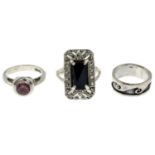 A selection of rings, to include an onyx and pyrite ring.