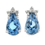 A pair of blue topaz and diamond stud earrings.Stamped 375.Length 0.8cms.