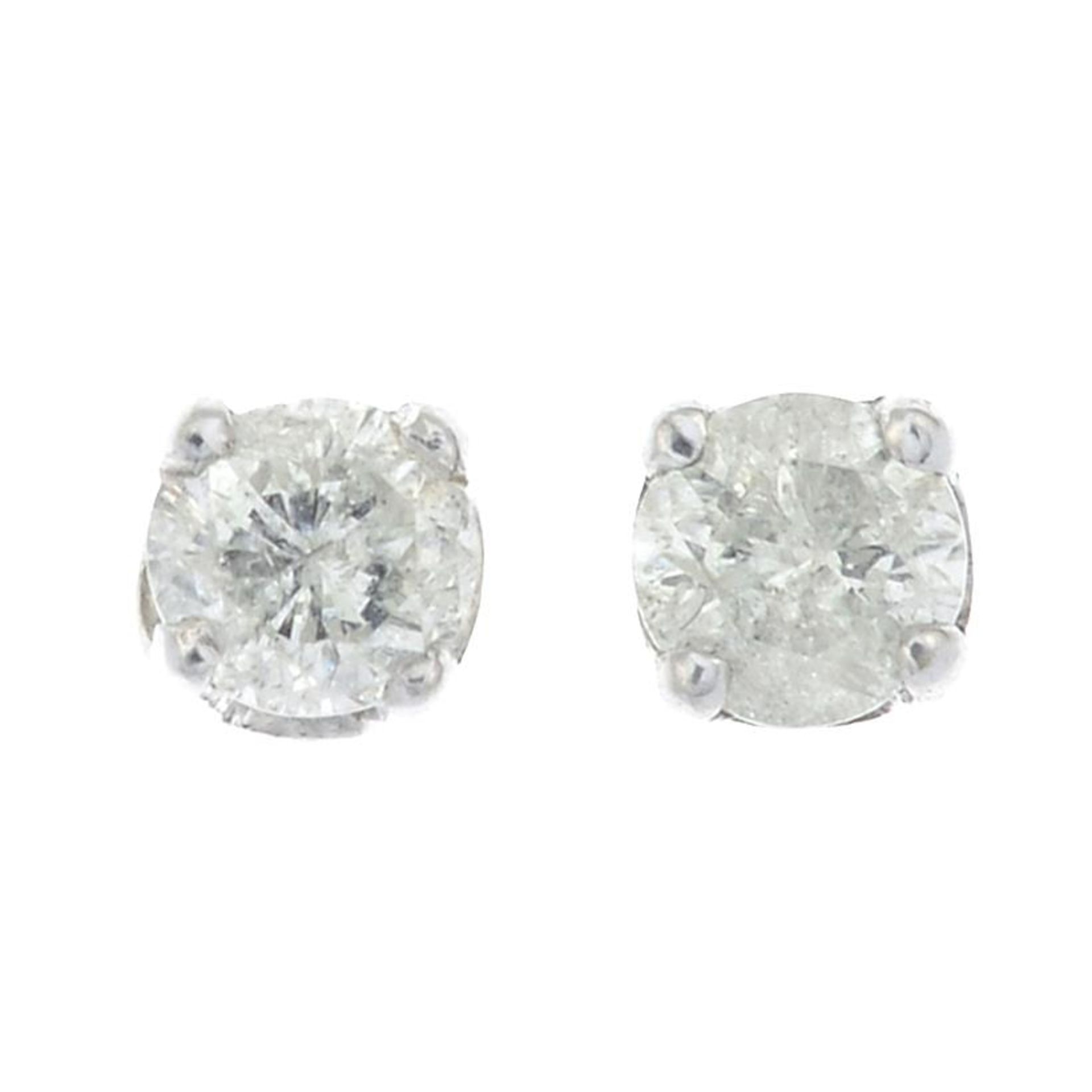 A pair of diamond stud earrings.