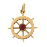 A red glass eight spoke wheel pendant.Stamped 750.Length 2.9cms.