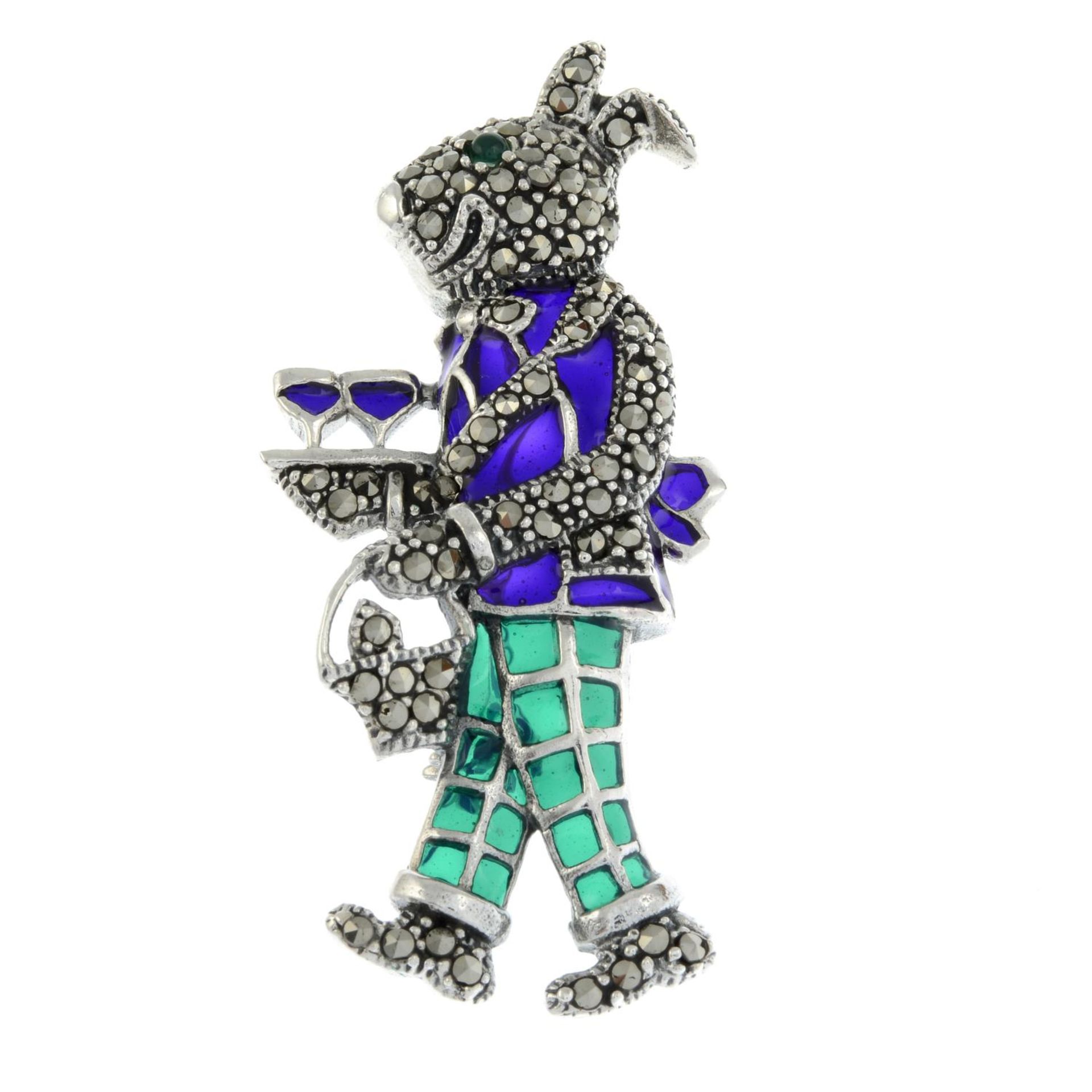 An emerald and marcasite plique-a-jour brooch of a hare serving drinks.May also be worn as a