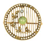 An Edwardian peridot and split pearl brooch, with openwork detail.