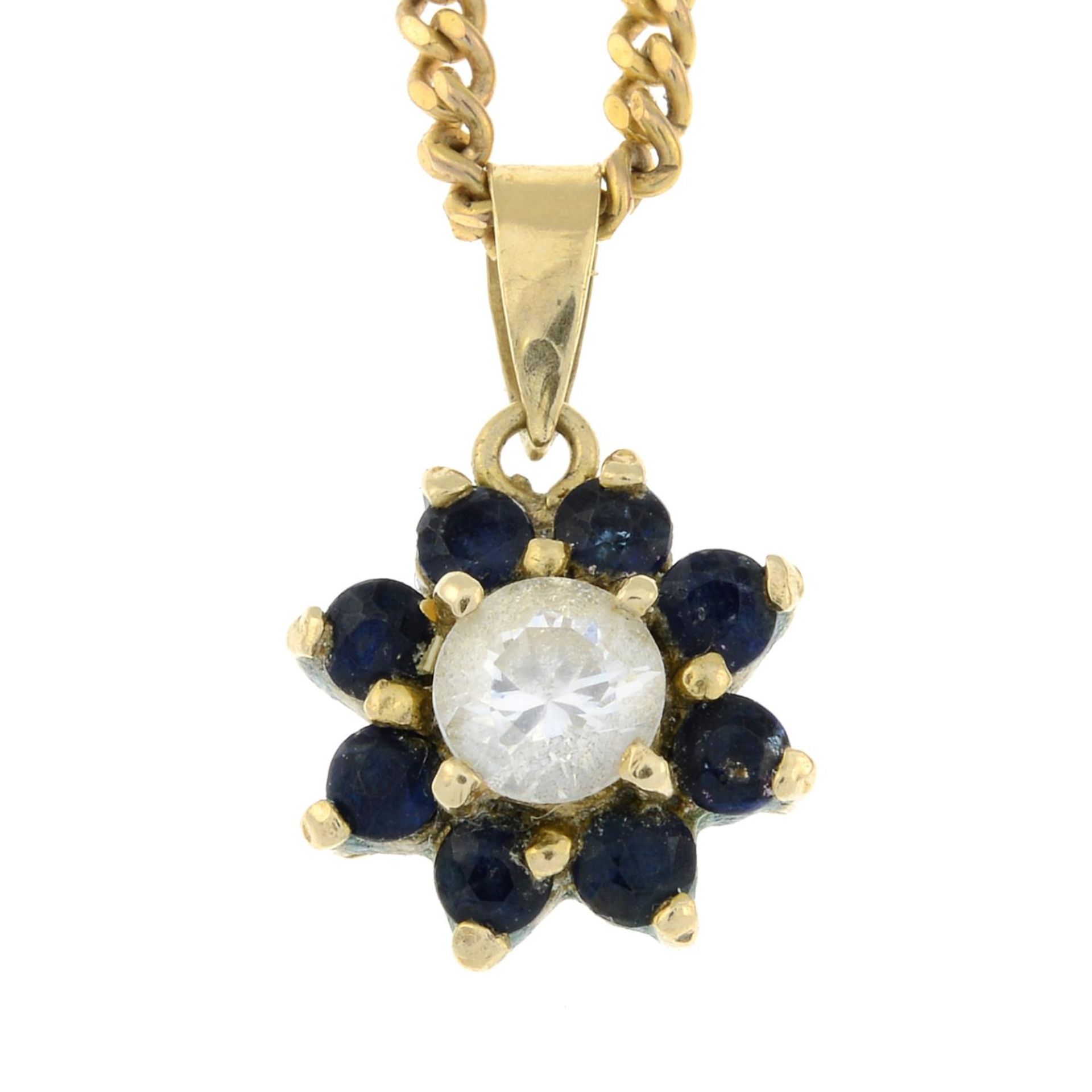 A sapphire and cubic zirconia cluster pendant,