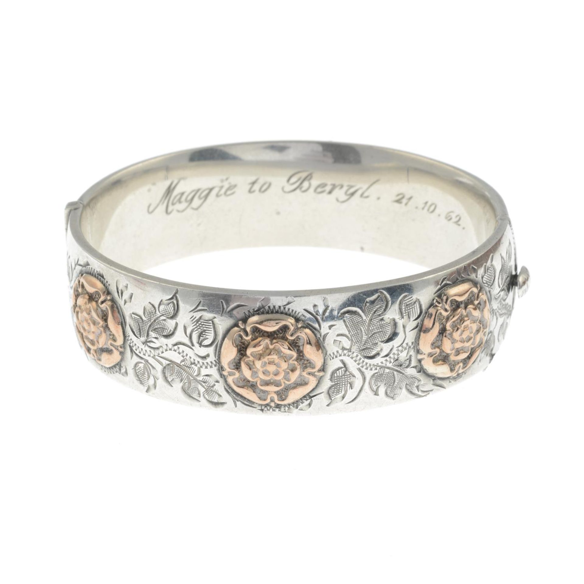 A silver engraved hinge bangle with Tudor rose appliqué.