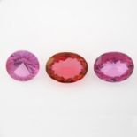 Three vari-shape pink topaz.