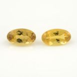 A pair of oval shape heliodors, weighing 9.46ct.
