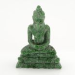 A carved jadeite, weighing 40ct.