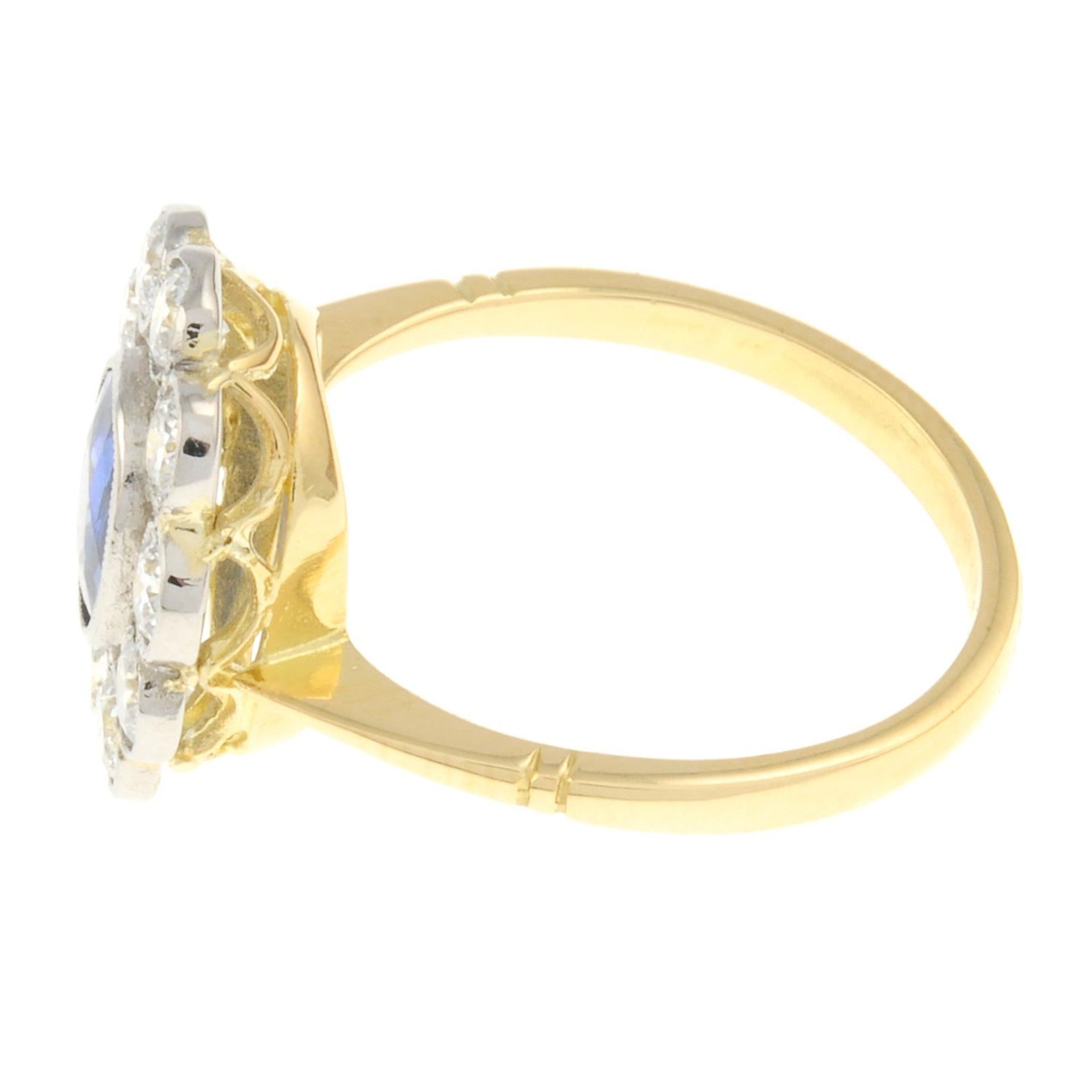A sapphire and brilliant-cut diamond cluster ring.Sapphire weight 0.80ct.Estimated total diamond - Image 2 of 4