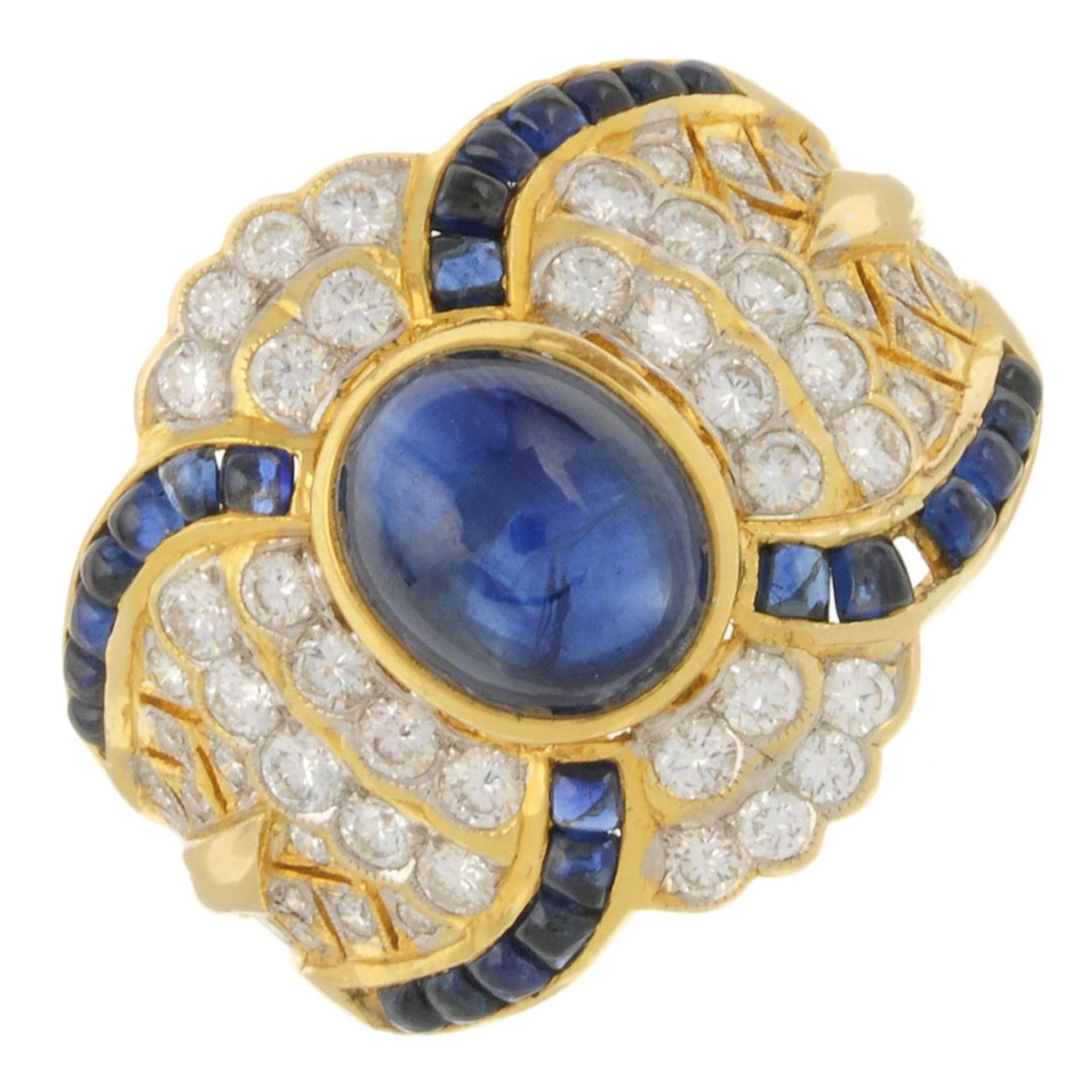 A sapphire cabochon and brilliant-cut diamond dress ring.Principal sapphire calculated weight