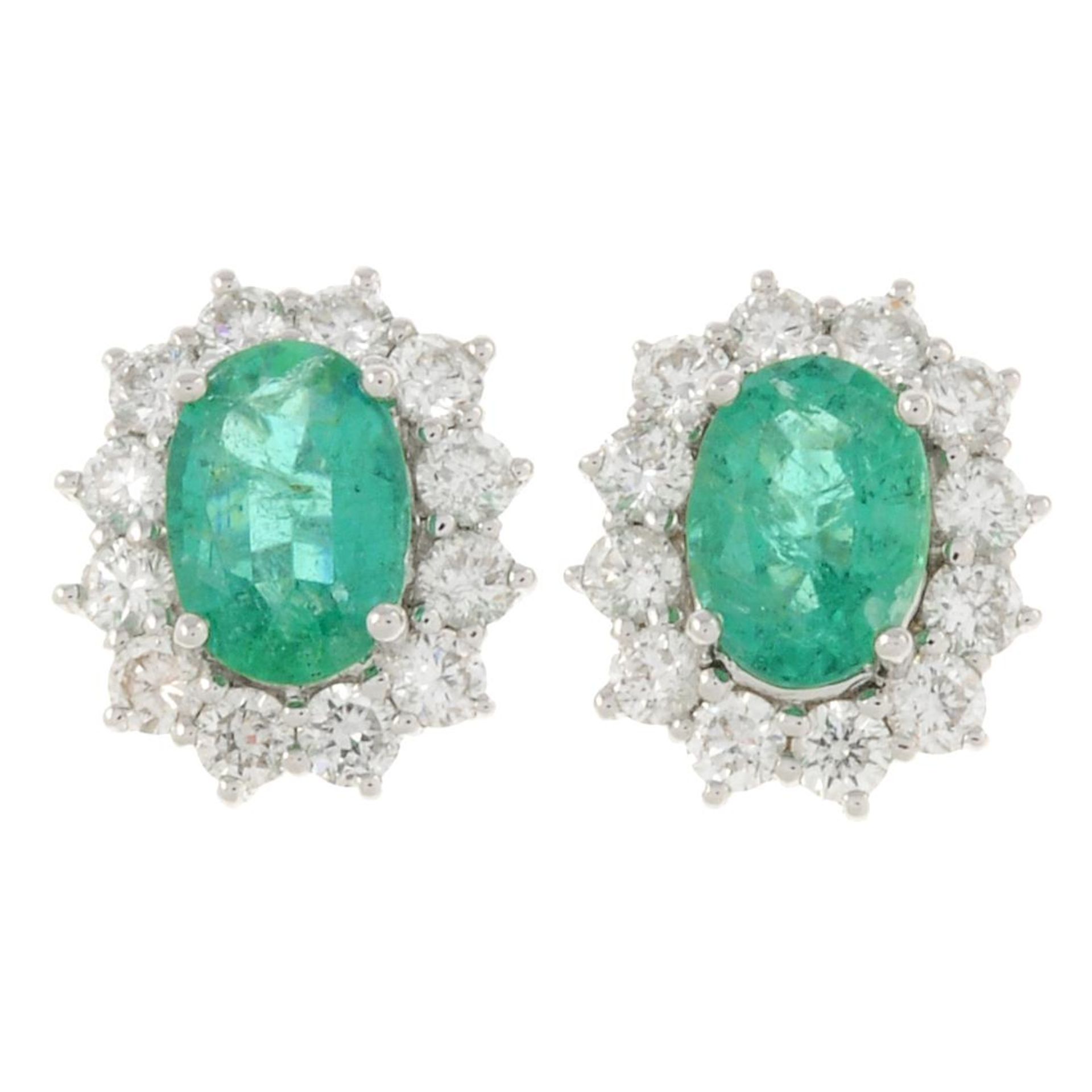 A pair of 18ct gold emerald and brilliant-cut diamond cluster earrings.Total emerald weight