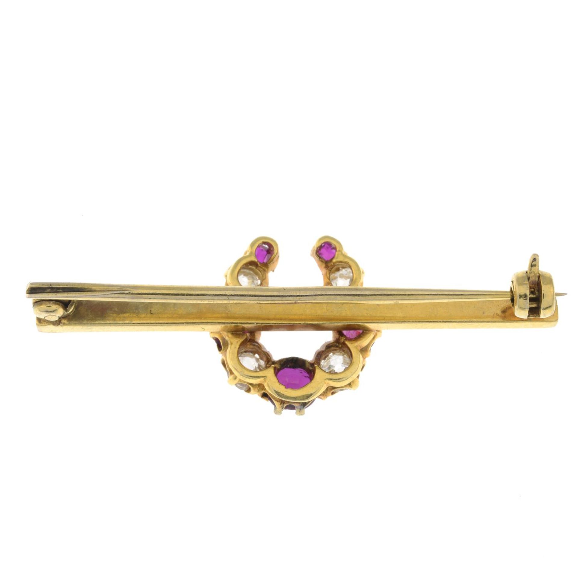 An early 20th century gold old-cut diamond and ruby horseshoe brooch.Estimated total diamond weight - Image 2 of 2