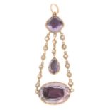 A 19th century gold foil-backed amethyst and split pearl pendant.Length 5cms.