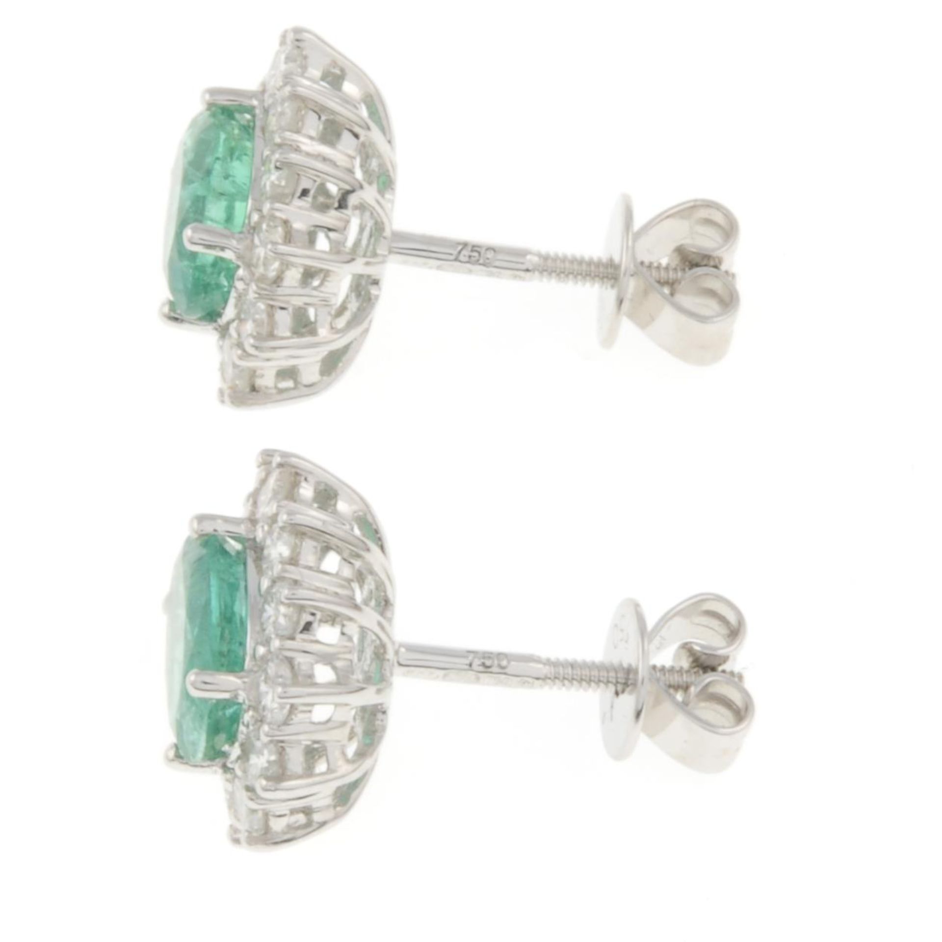 A pair of 18ct gold emerald and brilliant-cut diamond cluster earrings.Total emerald weight - Bild 2 aus 3