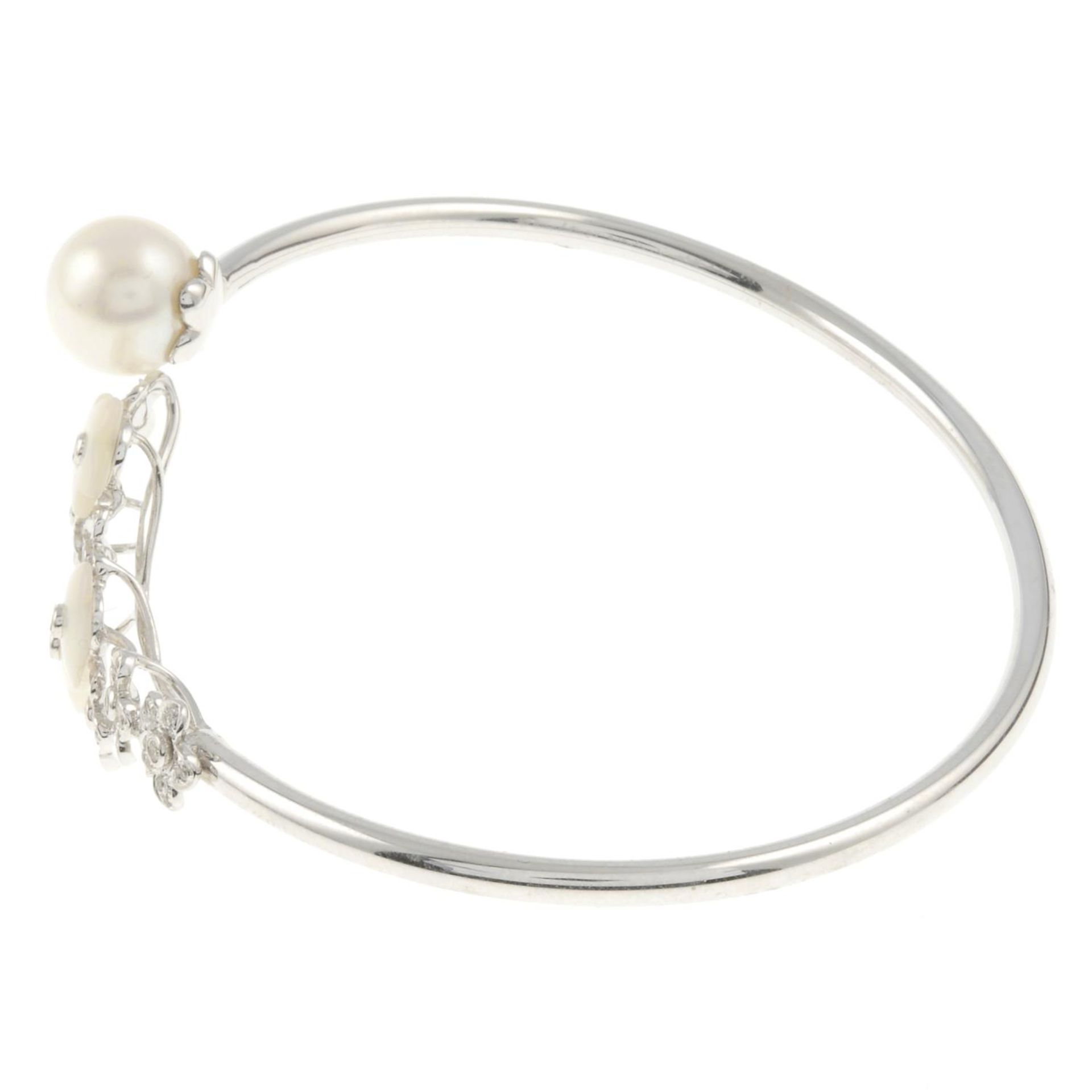 A cultured pearl, mother-of-pearl and brilliant-cut diamond bangle. - Image 2 of 3