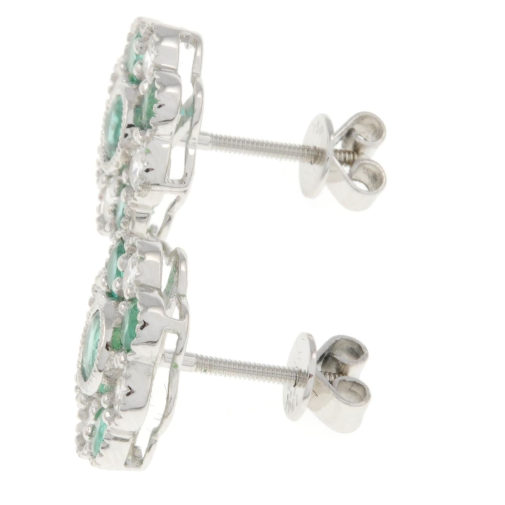 A pair of 18ct gold emerald and brilliant-cut diamond floral cluster earrings.Total emerald weight - Image 2 of 3