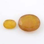 Four oval shape glass-filled yellow sapphires and a further yellow sapphire within a GLI seal,