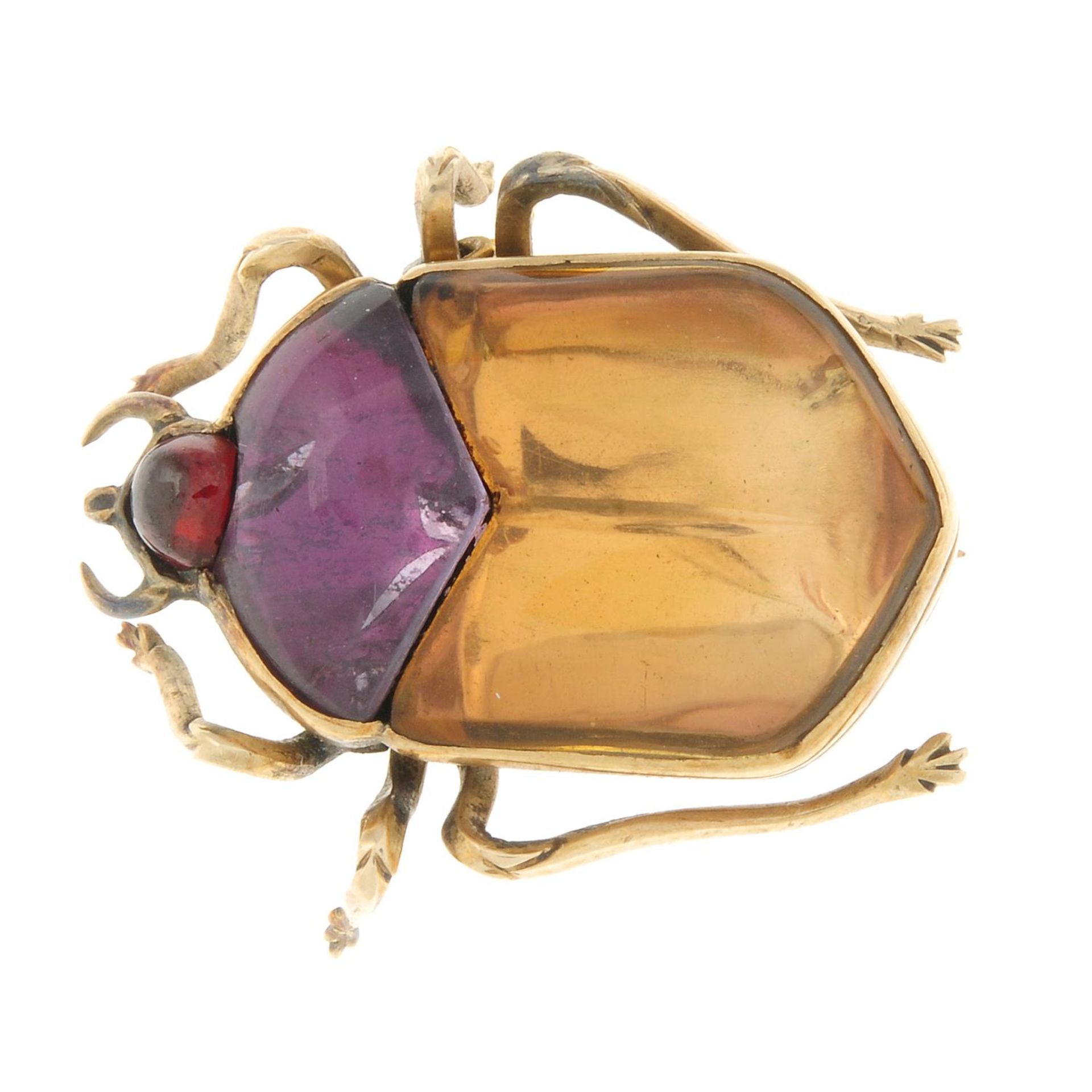 An late Victorian foil-back citrine, amethyst and garnet scarab beetle brooch.Length 2.7cms.