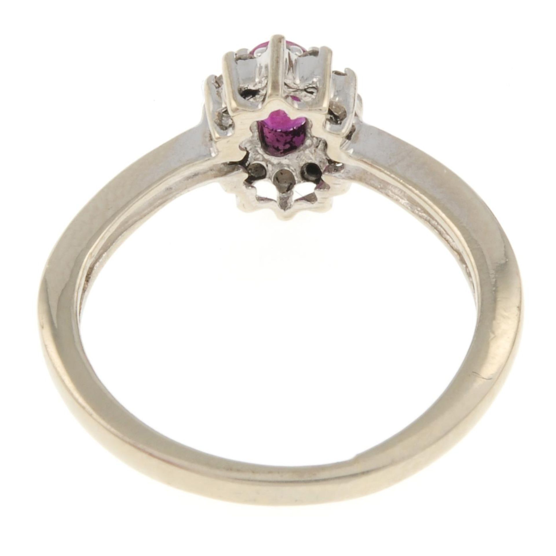 A ruby and diamond cluster ring.Estimated total diamond weight 0.10ct.Stamped 14k.Ring size K. - Image 3 of 3