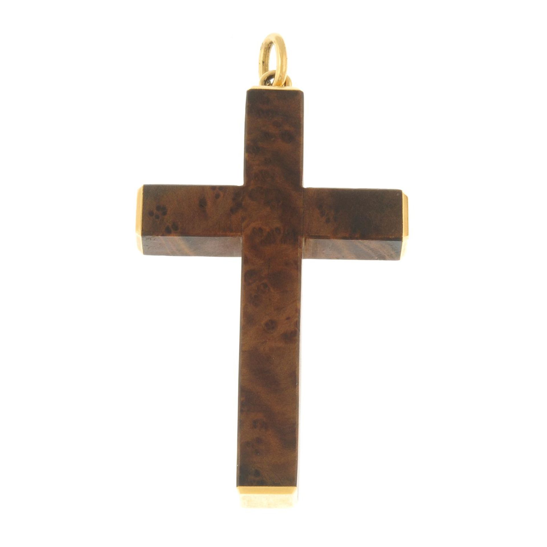 A wooden cross pendant, with polished terminals and surmount.Surmount with foreign marks.