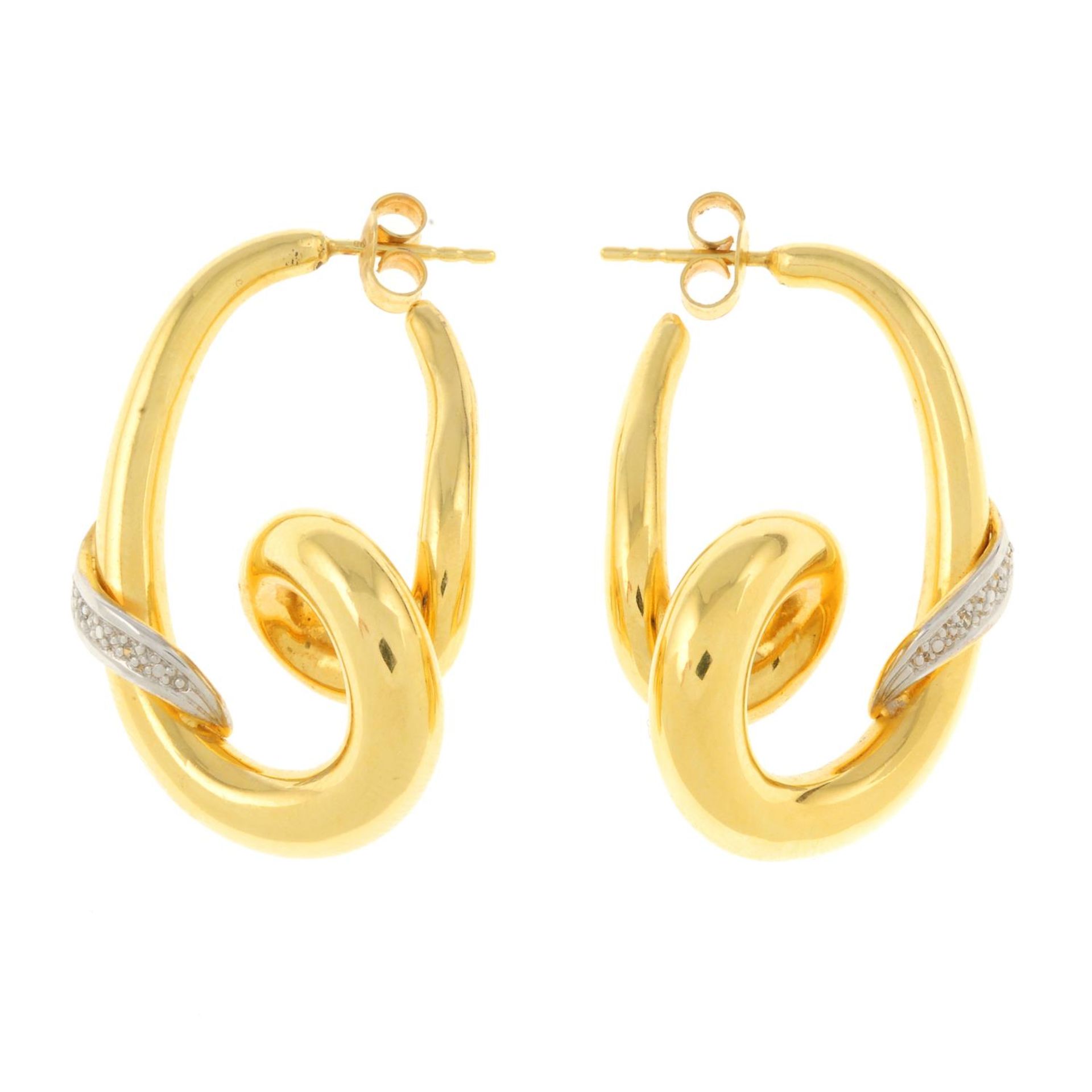 A pair of spiral earrings, with diamond accents.