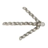 A single-cut diamond arrow brooch.Estimated total diamond weight 0.20ct.