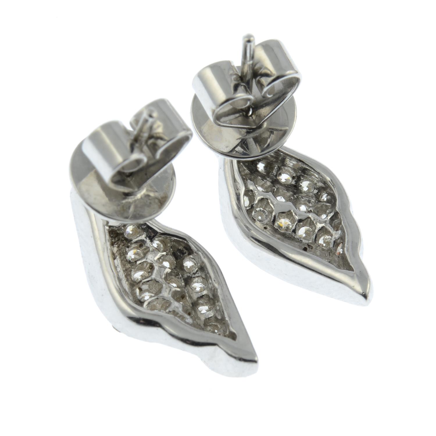 A pair of 18ct gold brilliant-cut diamond scroll motif earrings.Total diamond weight 0.55ct, - Image 3 of 3