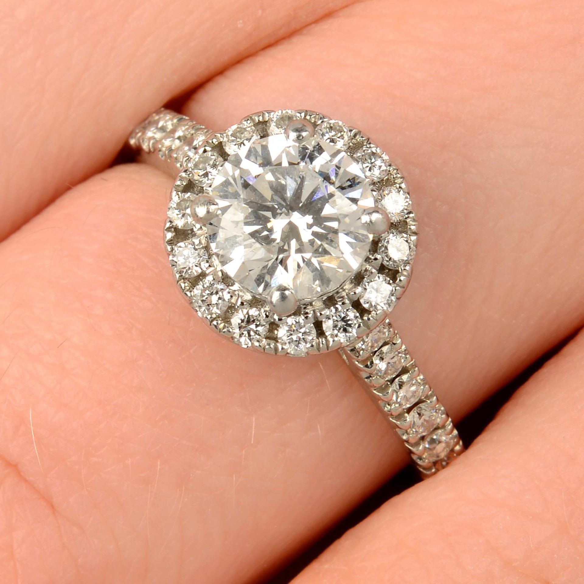 A platinum brilliant-cut diamond halo cluster ring.