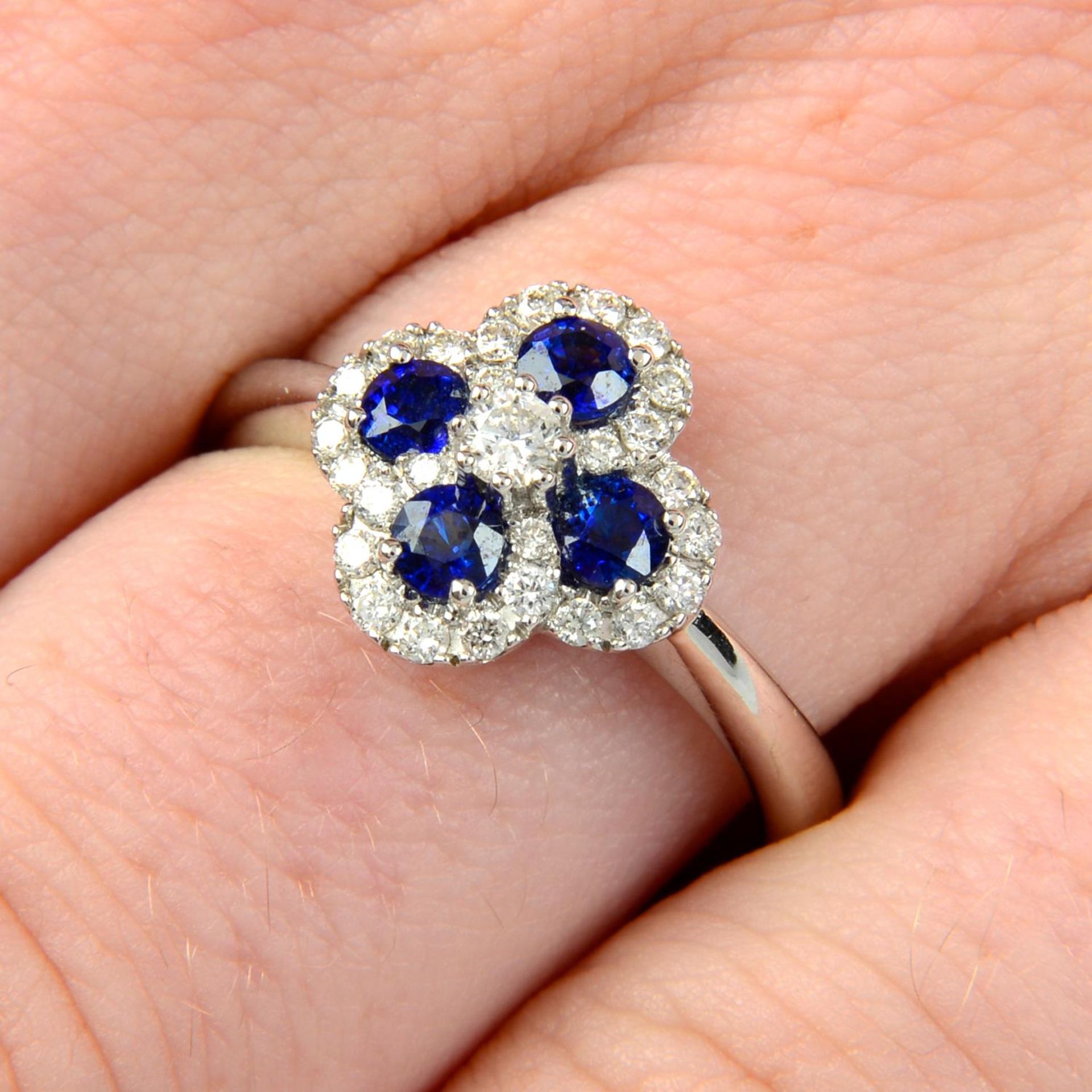 An 18ct gold sapphire and brilliant-cut diamond ring.Total sapphire weight 0.63ct.Total diamond
