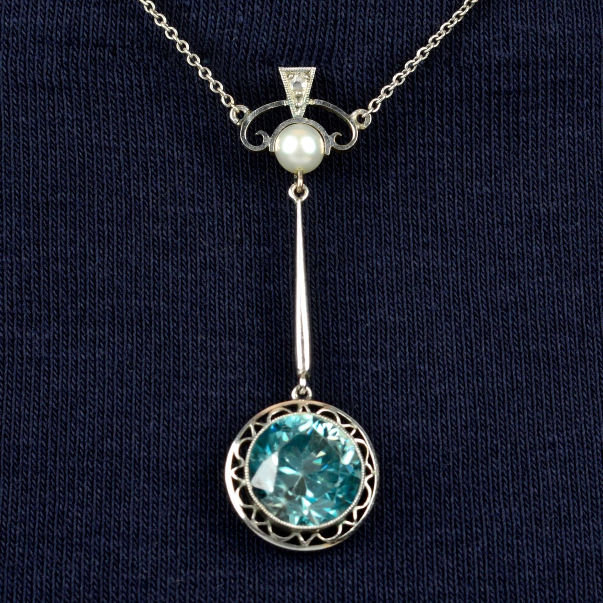 An early 20th century 9ct gold blue zircon and cultured pearl necklace.